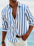 Man wearing a grey and white striped loose-fit long-sleeved casual shirt