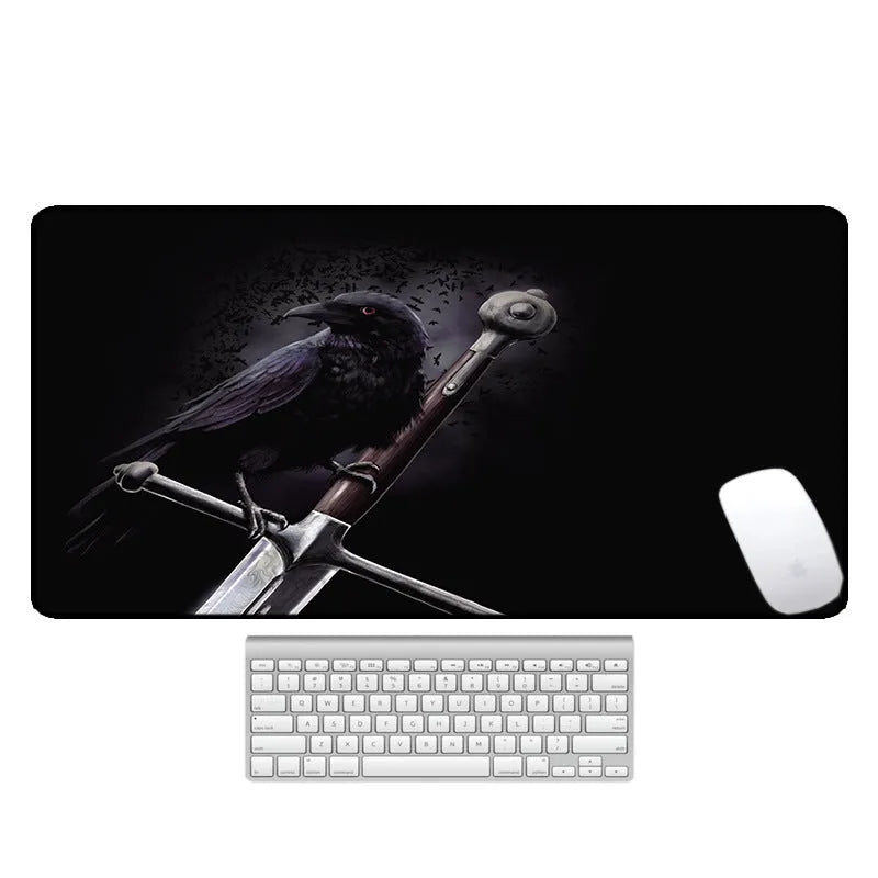 Large black rubber desk mouse pad with a printed geometric pattern, shown on a wooden desk.