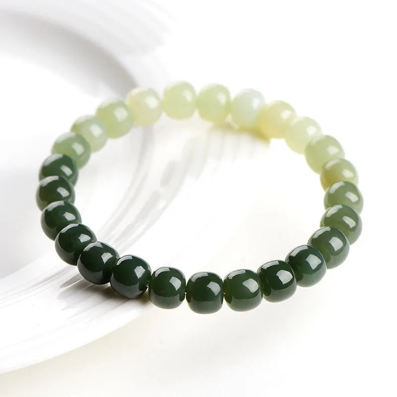 Natural Hetian jade bracelet showing water gradient colour on polished beads.