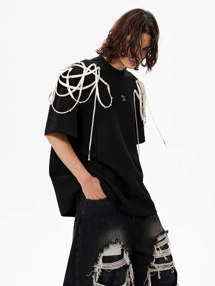 Black loose-fit T-shirt with padded shoulders featuring rivet ribbon detail, short sleeves, and round neck