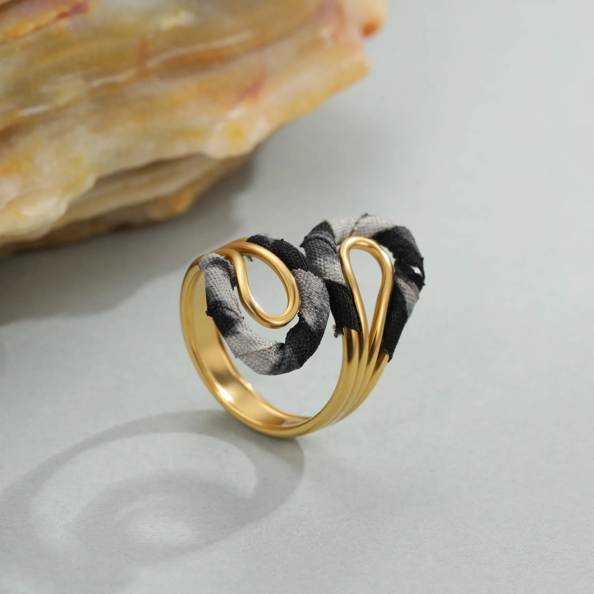 Stainless steel open mouth ring with leopard print in geometric shape on a hand.
