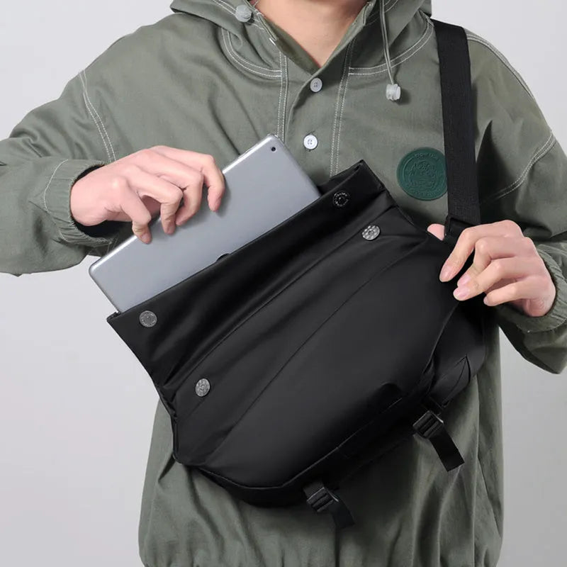 Men's grey PU crossbody chest bag showing zipper opening and adjustable shoulder strap.