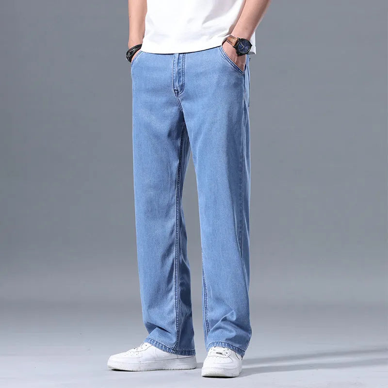 Man wearing light blue loose straight-leg Lyocell jeans with a zipper fly.
