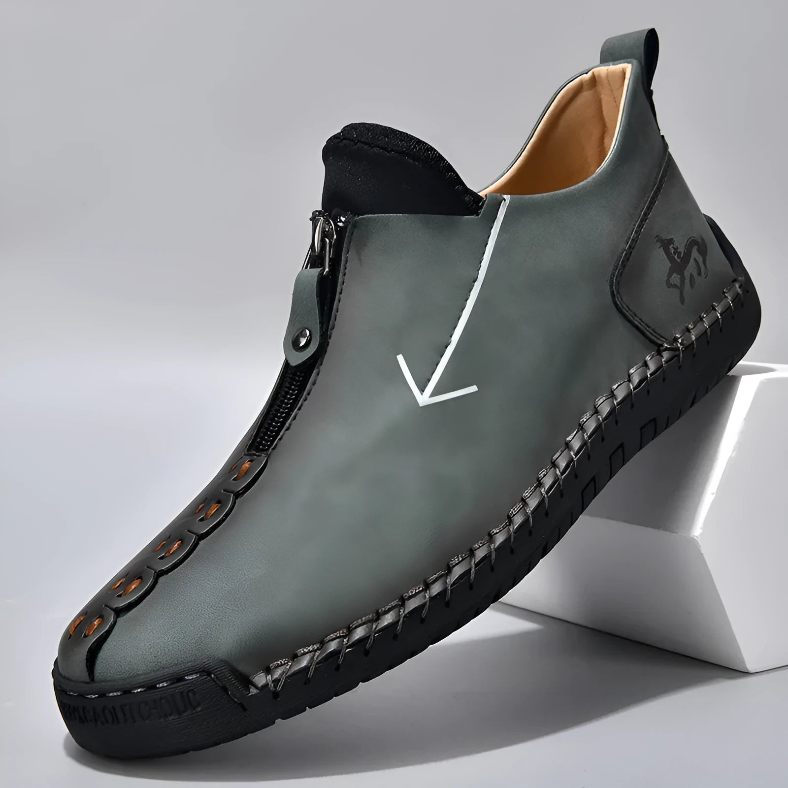 Men's black front-zip casual boots with round toe and low heel, showing the side zipper and rubber sole.