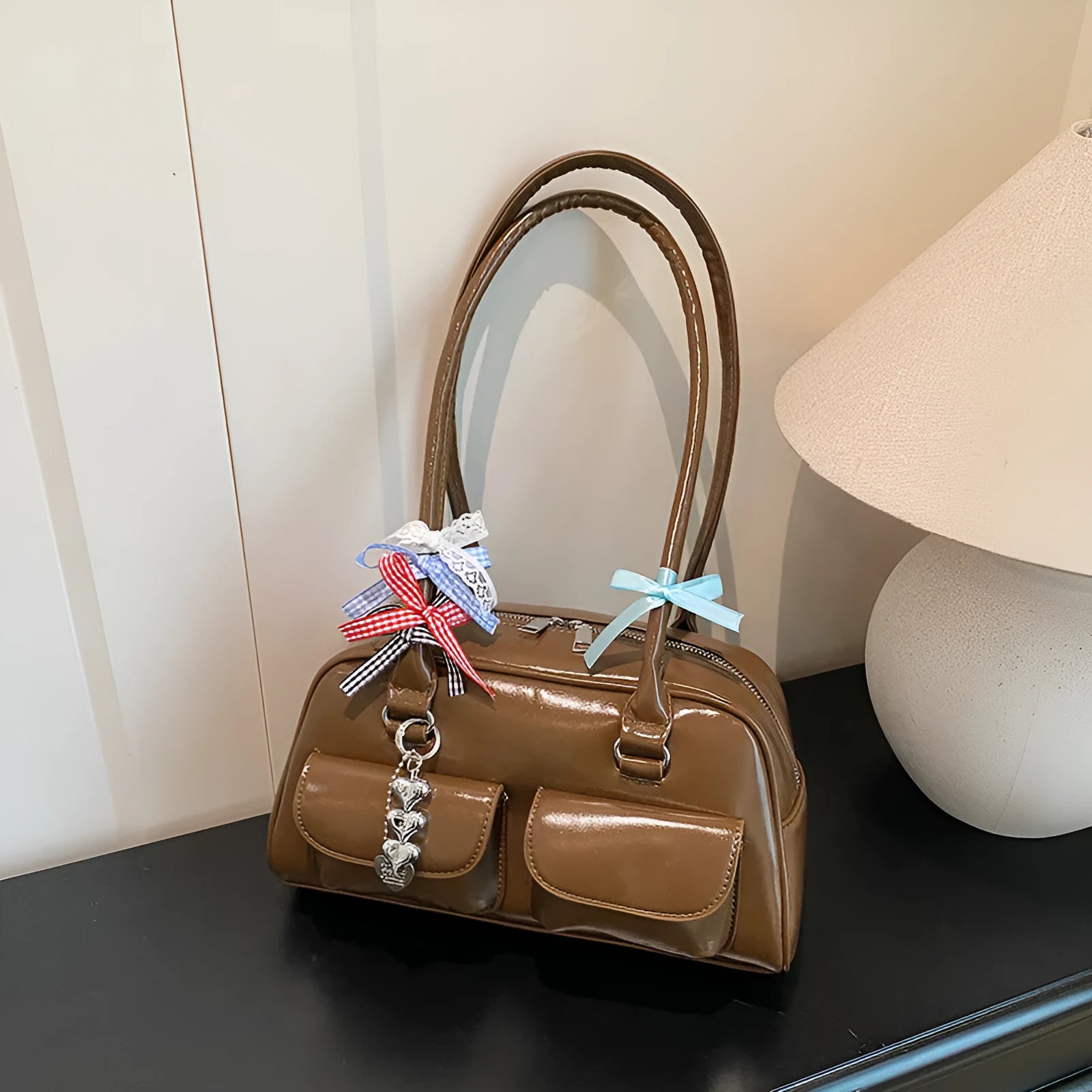 Retro one-shoulder pillow handbag in PU leather, shown in black with a flap closure and double straps.