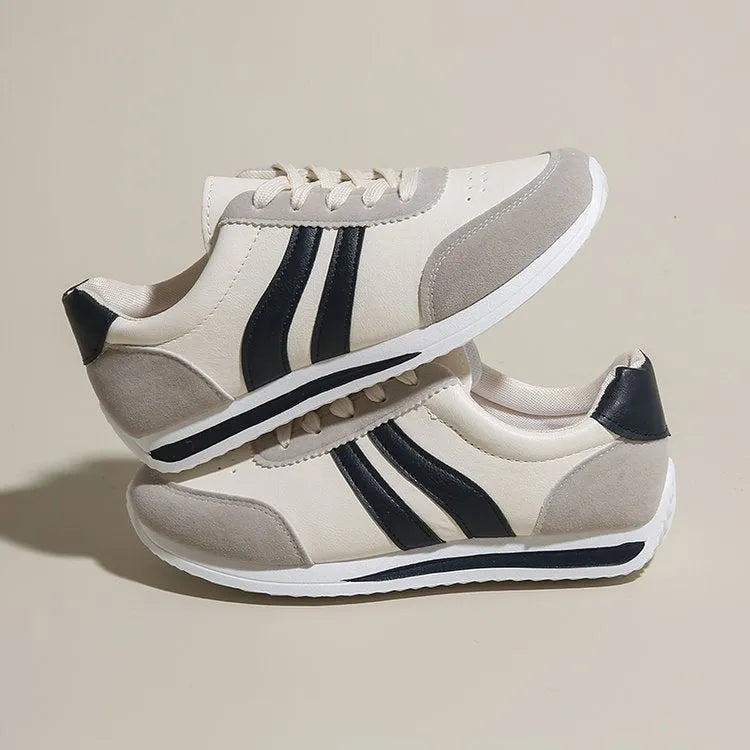 Red and blue lace-up low-top running sneakers with mesh upper and rubber sole on a white background.