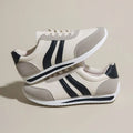 Red and blue lace-up low-top running sneakers with mesh upper and rubber sole on a white background.