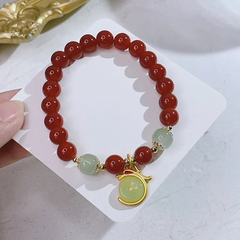Handmade red agate bracelet with dragon and lucky bag Chinese designs for women.