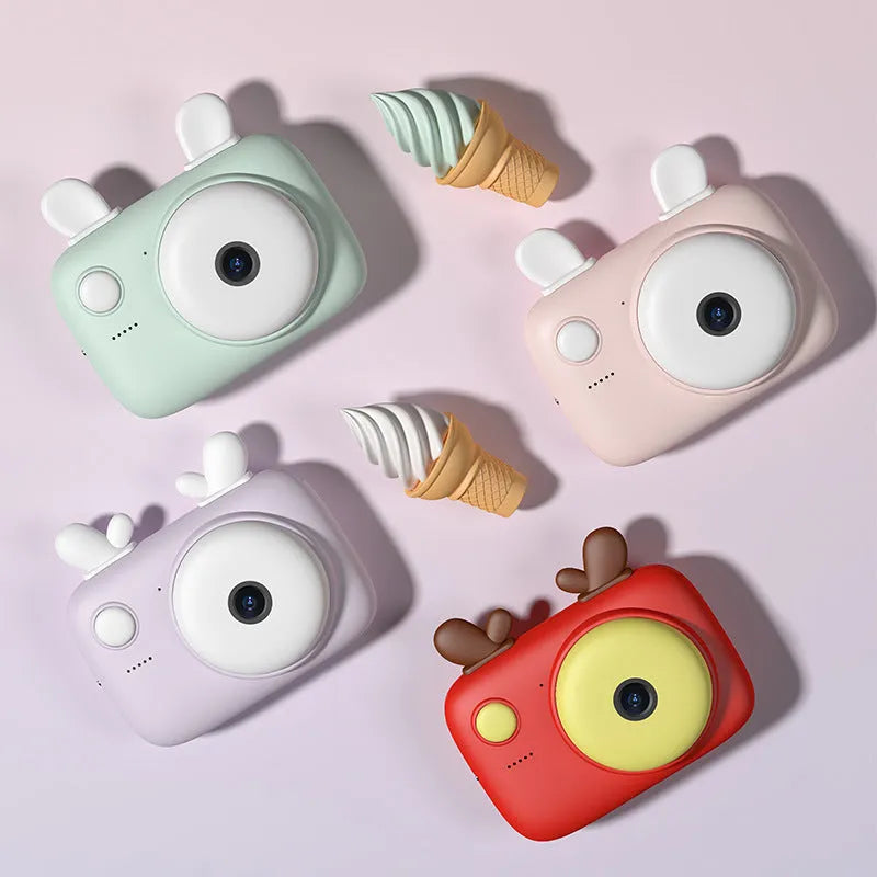 A2 Macaron design kids digital camera in green, showing front and rear lenses and 2.4 inch screen.