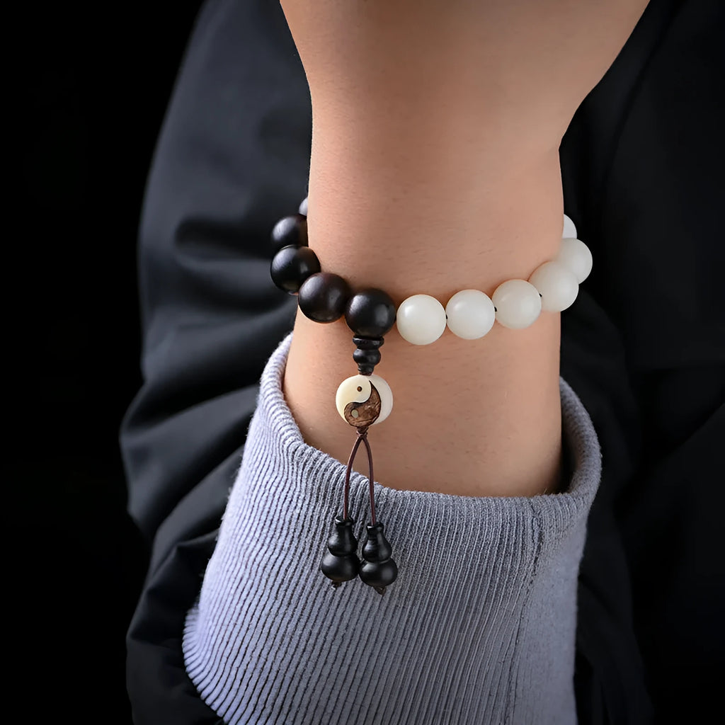Handcrafted Bodhi seed bracelet with white Corypha Umbraculifera and Blackwood beads in eight-diagram pattern