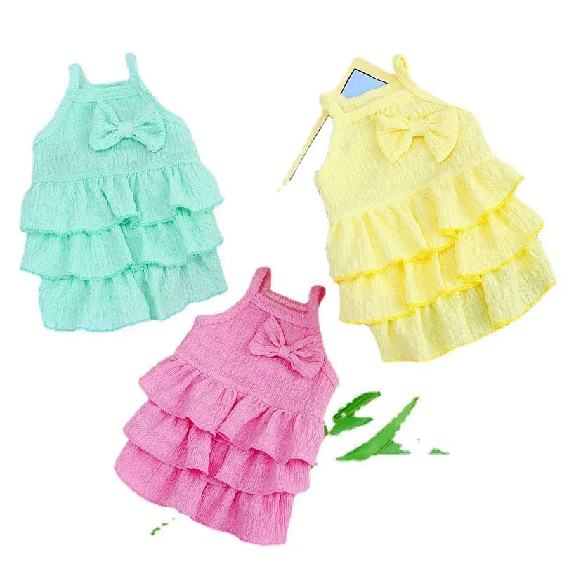 Small dog wearing candy layered skirt princess dress in rose red colour