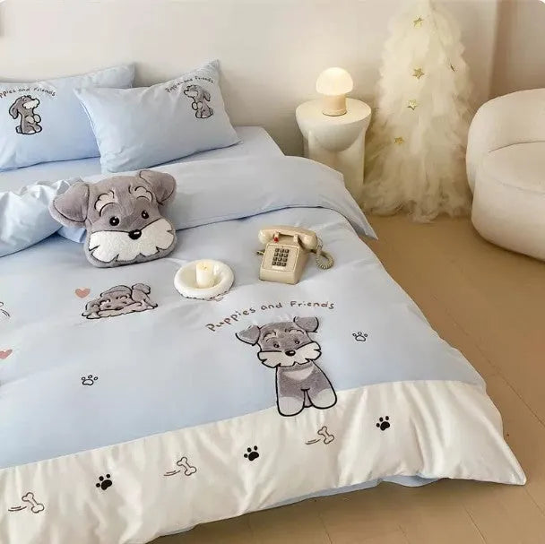 Schnauzer dog cartoon embroidery design on a light-coloured cotton quilt cover and pillowcase from a four-piece bedding set.