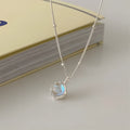 Polished sterling silver necklace for women with round geometric stone pendant on curb chain.