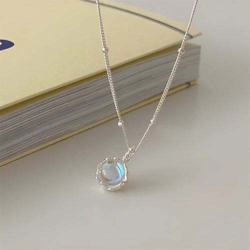 Polished sterling silver necklace for women with round geometric stone pendant on curb chain.