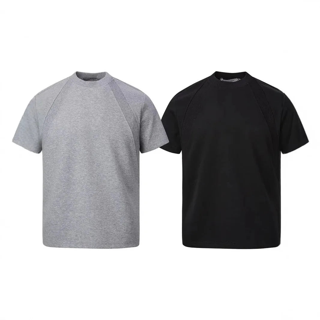 Man wearing a loose-fit grey short sleeve polyester top with air layer stitching.