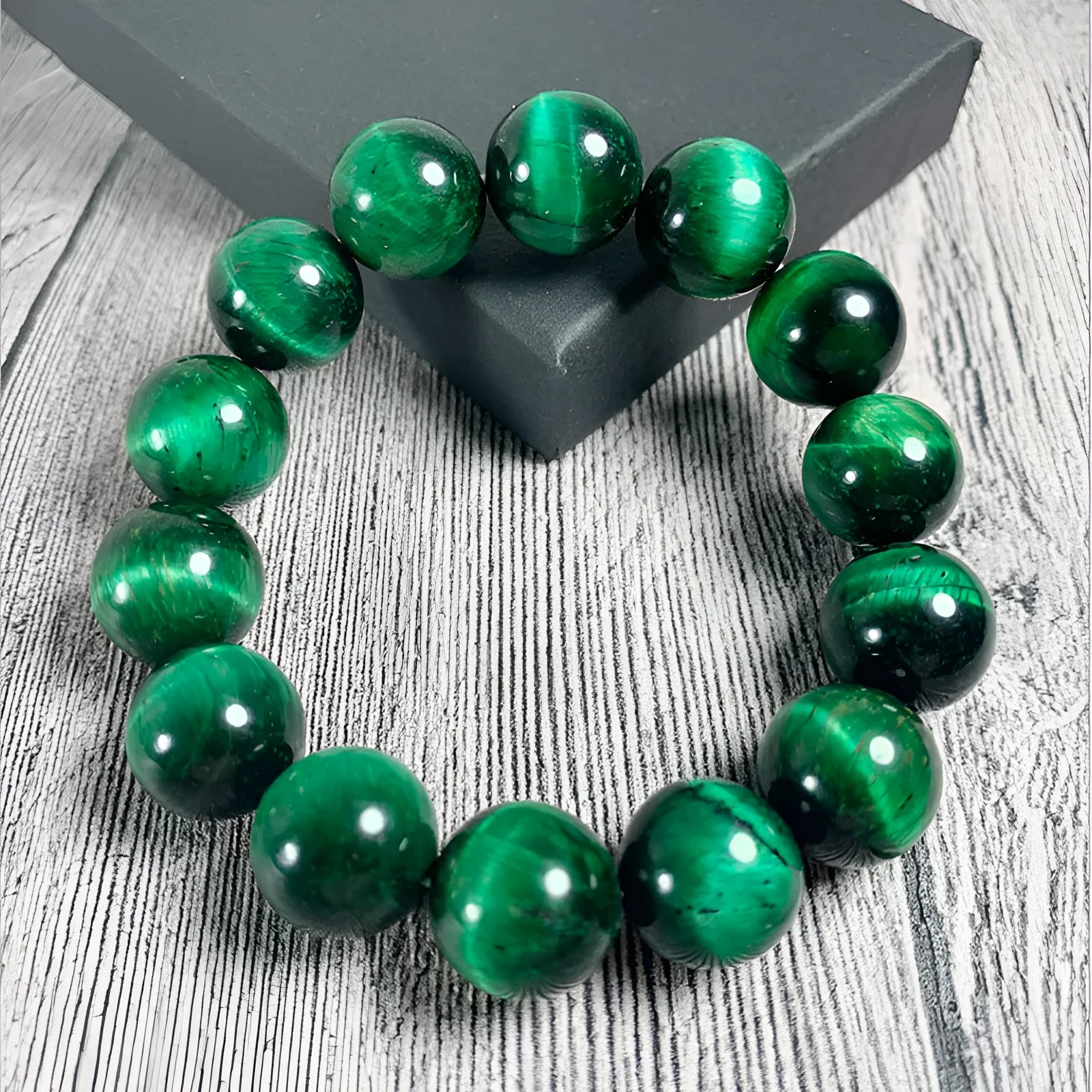 Green Tiger Eye stone beaded bracelet with geometric shaped beads on a wrist.