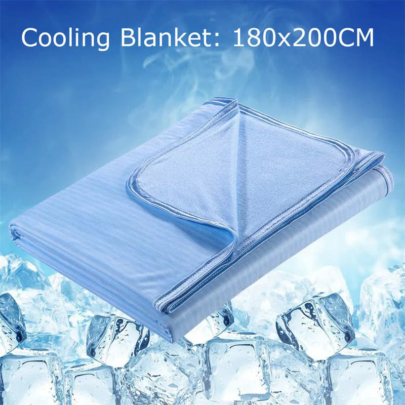 Blue and grey cooling blanket with Japanese Q-Max fibres on a bed.