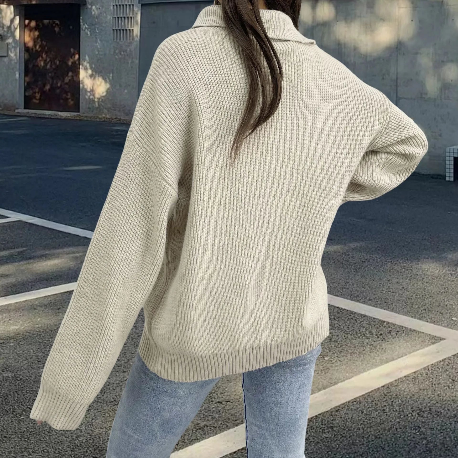 Woman wearing a light khaki Alpaca wool pullover sweater with an oblique zip and turtleneck.