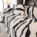 Zebra pattern flannel sofa slipcover in caramel colour, shown draped over a sofa with matching square pillow.