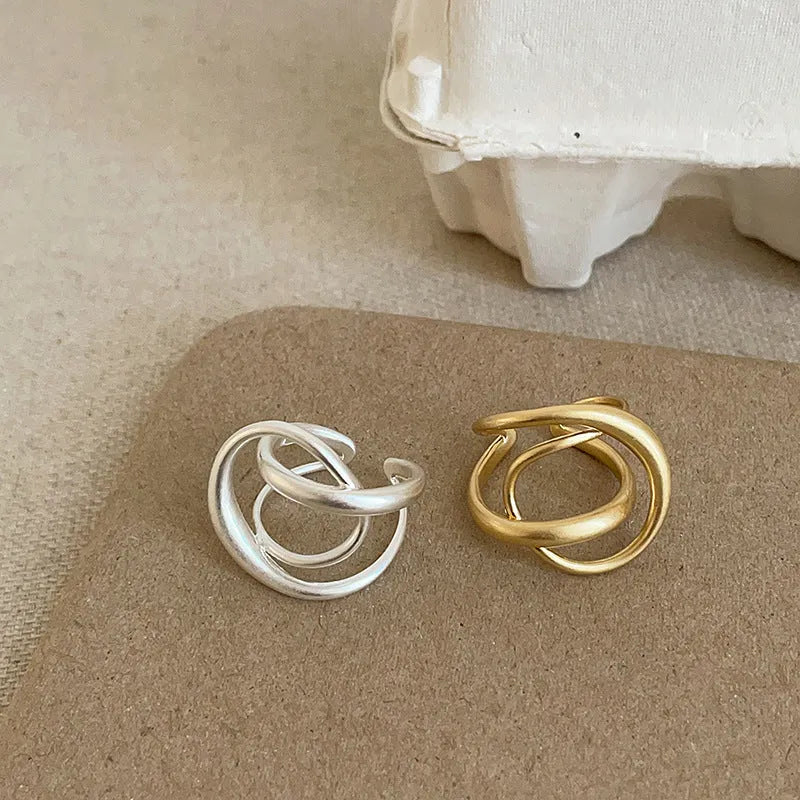 Geometric open ring with interlaced matte metal design in gold or silver electroplated finish