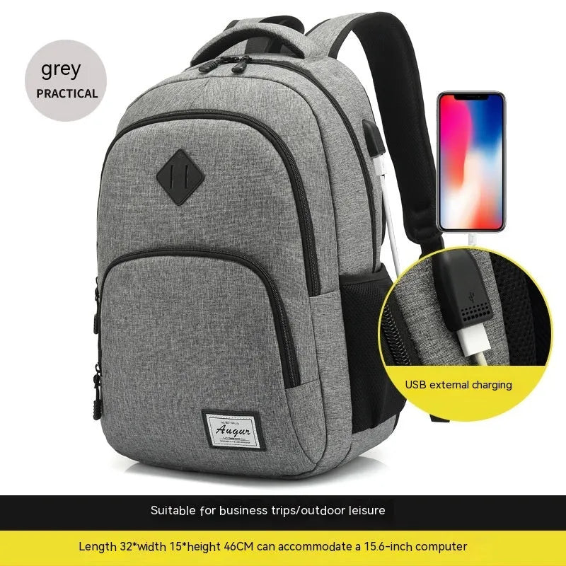 Gray nylon backpack with USB charging port and trolley sleeve on a suitcase.