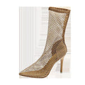 Gold women's high heel sandals with pointed stiletto heel and mesh upper on a rubber sole.