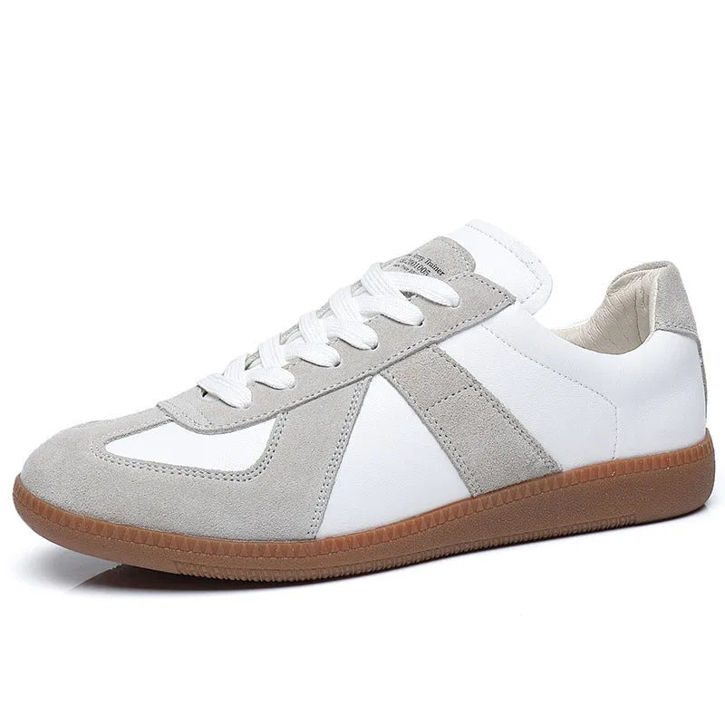 White Japanese-inspired retro unisex sneakers with low-top lace-up design on a rubber sole