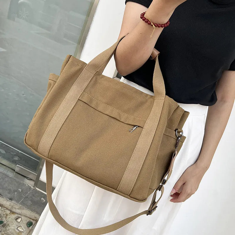 Canvas tote bag showing multiple internal compartments and both sides zipper openings in horizontal square shape