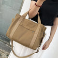 Canvas tote bag showing multiple internal compartments and both sides zipper openings in horizontal square shape