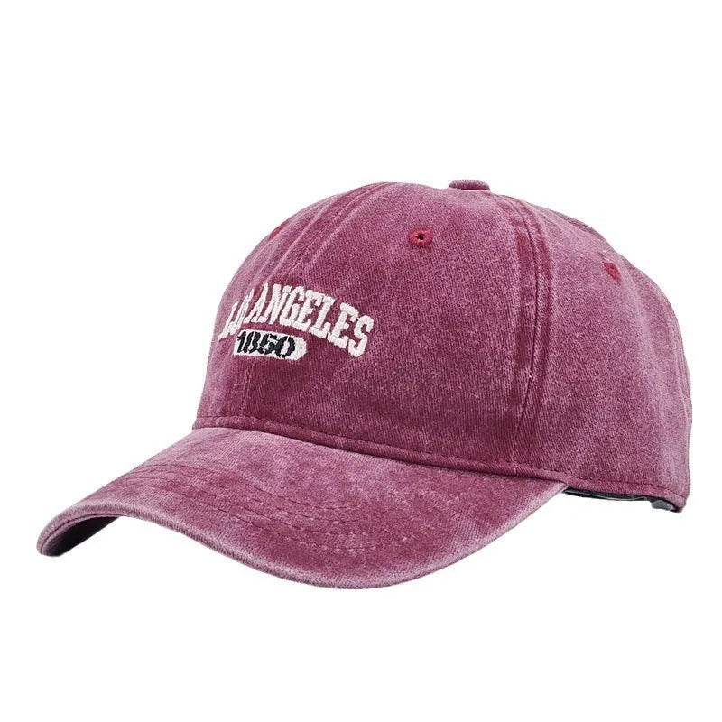 Adult personalised embroidered peaked cap in beige with adjustable strap and distressed lettering.