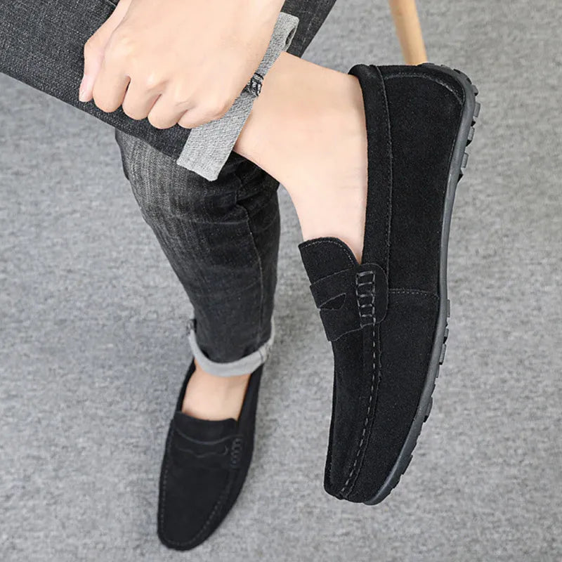 Men's suede loafers in black, blue, dark blue, wine red, and yellow colours showing round toe and flat sole
