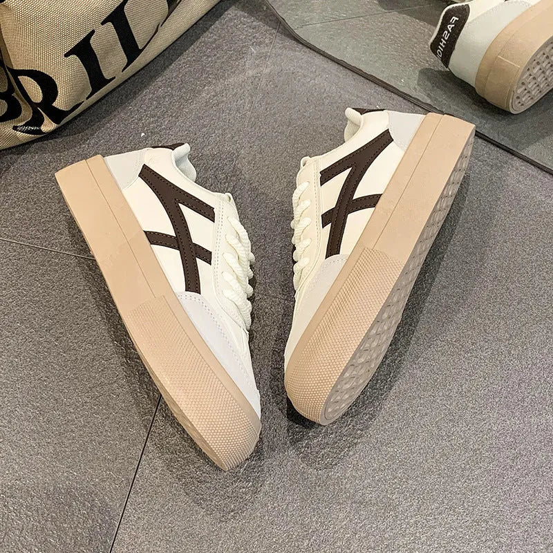 Low top blue board shoes with round toe and flat rubber sole on white background