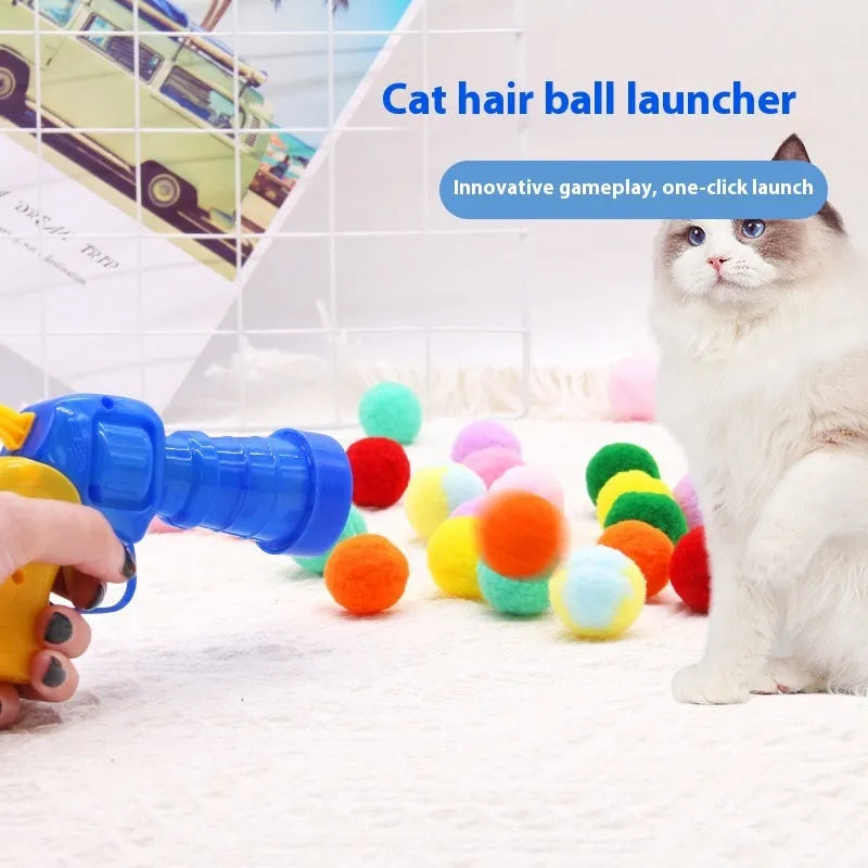Plush cat toy launch gun with soft yarn balls for interactive indoor pet play.