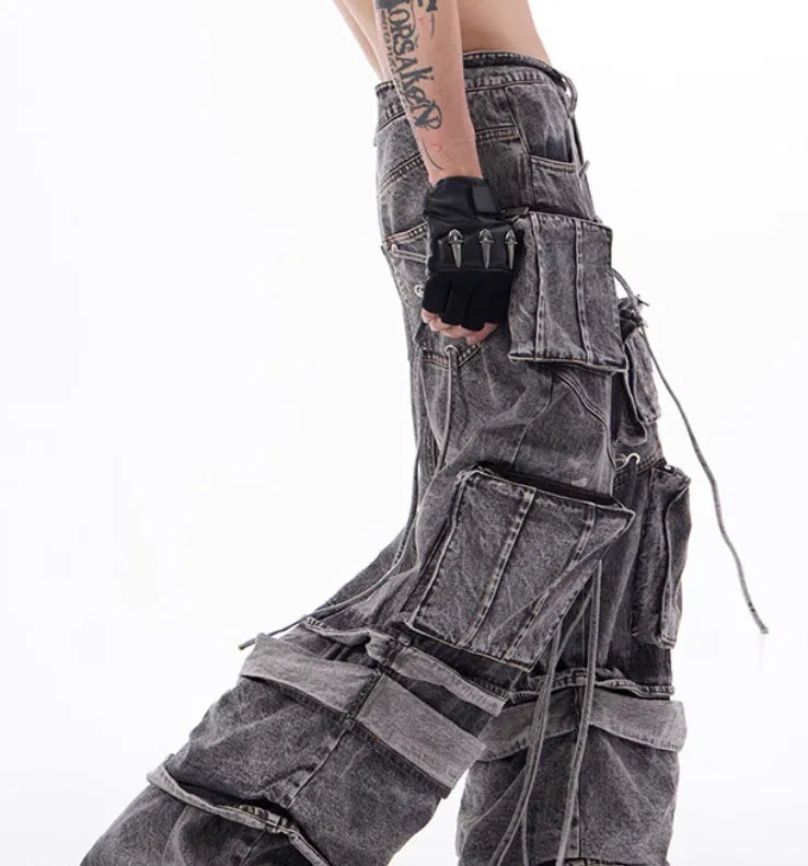 Grey distressed denim overalls for men with rope stitching on the legs and a mop pant cut.