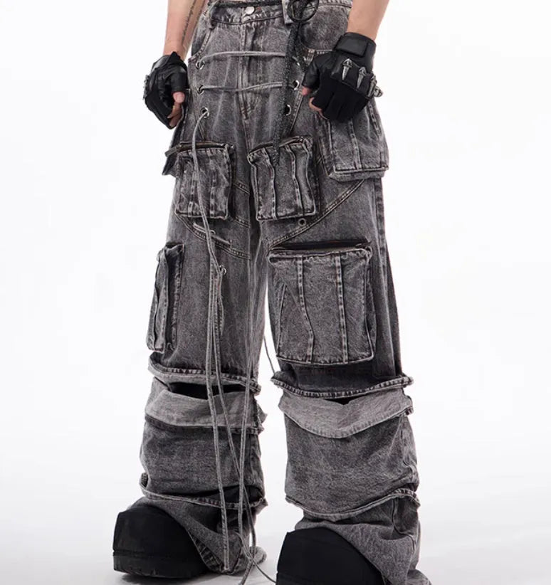 Grey distressed denim overalls for men with rope stitching on the legs and a mop pant cut.