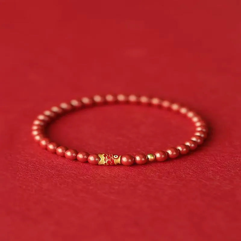 Natural cinnabar koi bracelet with golden ball charm in traditional Chinese style design