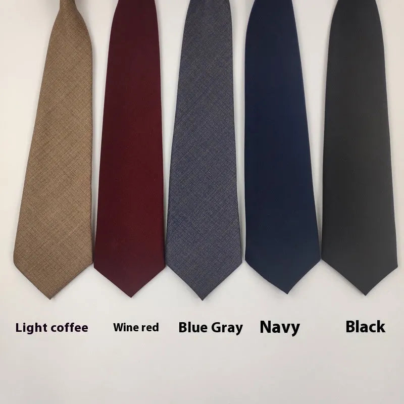 Solid navy blue men's cotton tie with arrow-type design on a white background.
