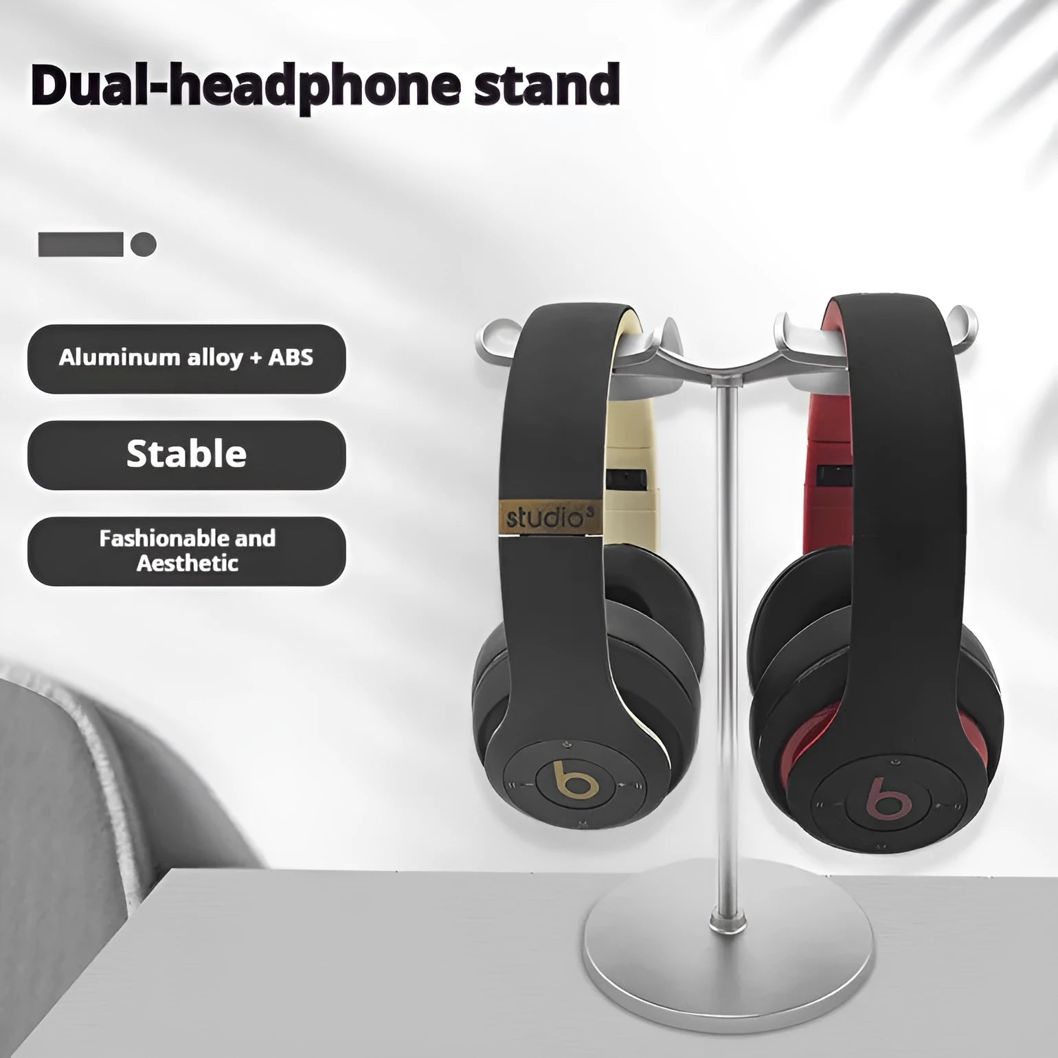 Desktop double-hanging earphone bracket in black holding two headphones on a desk