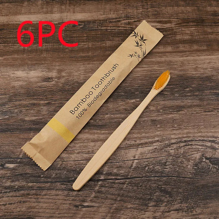 Set of ten bamboo toothbrushes with charcoal-infused bristles in assorted colours on a white background.