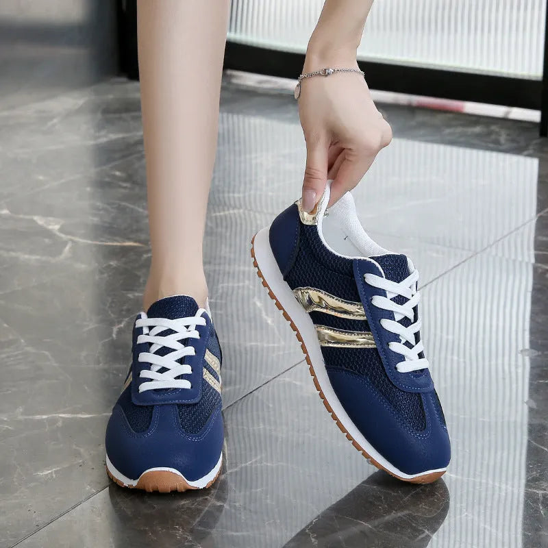 Blue women's casual sports shoes with cross shoulder straps and a lace-up front on a non-slip rubber sole.