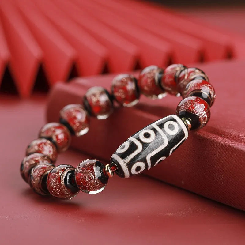 Close-up of a coloured glaze bracelet with traditional Chinese snake design and multi-coloured beads.