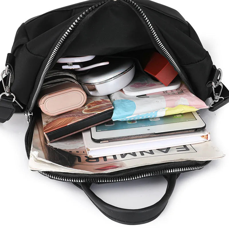 Large capacity soft PU commute backpack in black with three-dimensional pockets and internal mobile phone compartment