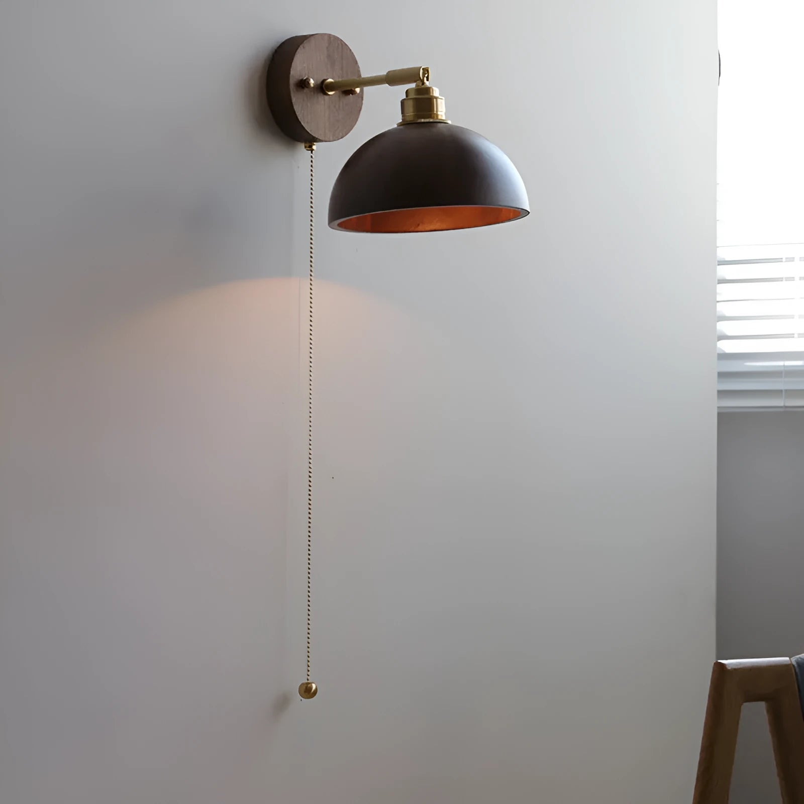 Nordic style walnut wood coloured wall-mounted bedside lamp with a fixed arm.