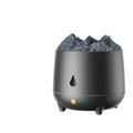 Black volcano-shaped ultrasonic humidifier with USB cable on wooden desk emitting mist