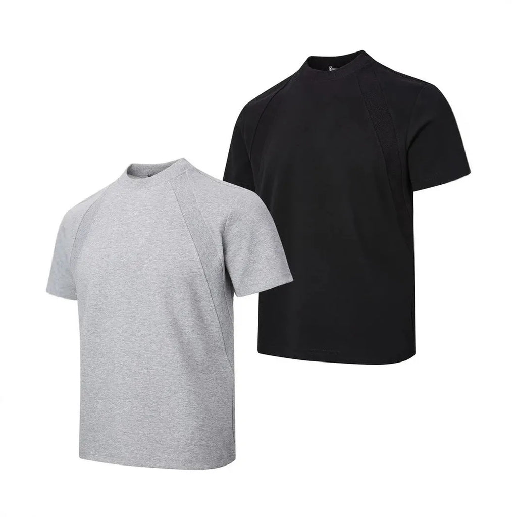 Man wearing a loose-fit grey short sleeve polyester top with air layer stitching.