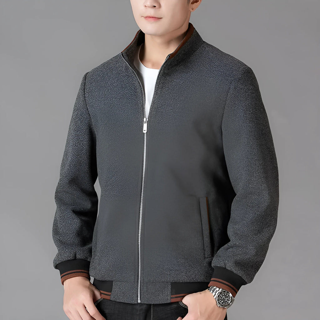 Men's grey polyester fleece jacket with long sleeves and a stick pocket, shown on a hanger.