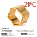 Stainless steel wide band ring with a geometric wave pattern design in an electroplated finish.