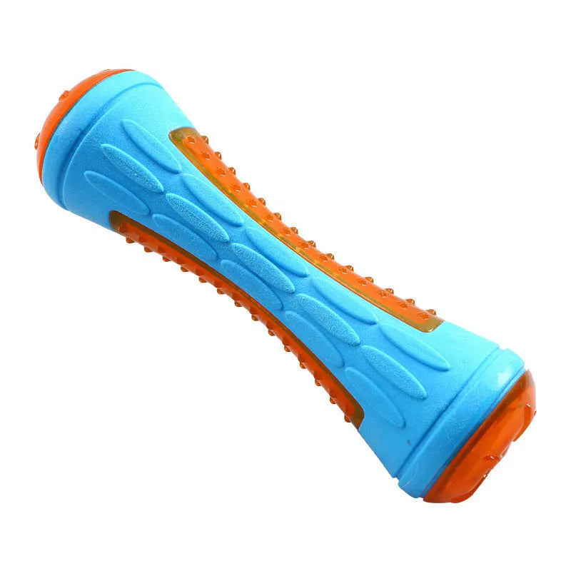 Set of three TPR dog toys: a blue squeaky ball, an orange barbell, and red tyres on grass.