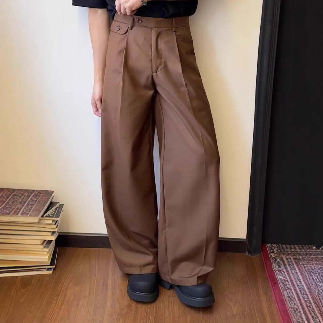 Men's straight-leg loose-fit trousers in brown and black colours on a hanger.