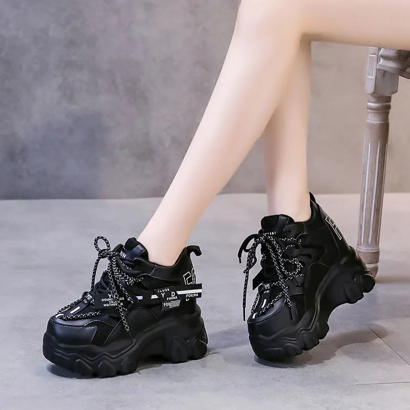 White women's low-top platform sports shoes with breathable mesh, cross strap, and rubber sole.